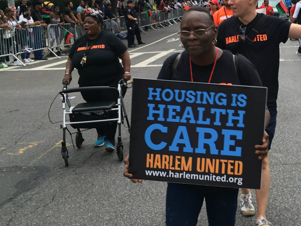 Harlem United "Housing is Healthcare" sign