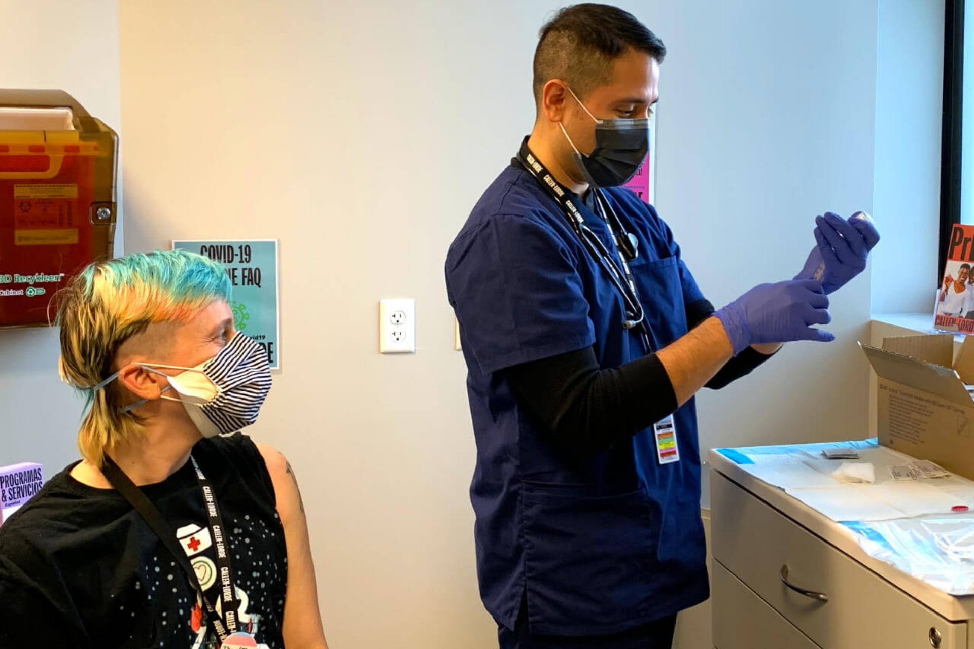 Healthcare worker prepares vaccine shot for waiting patient