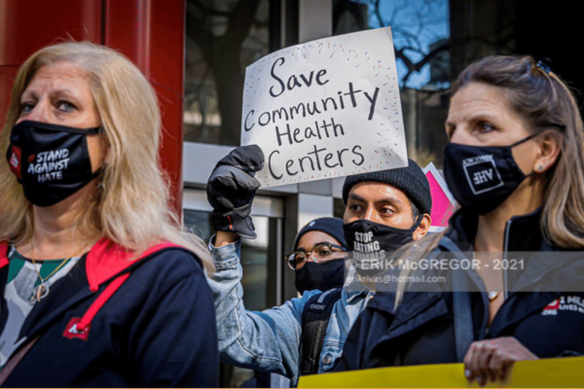 Activists at a rally. Sign reads "Save Community Health Centers"